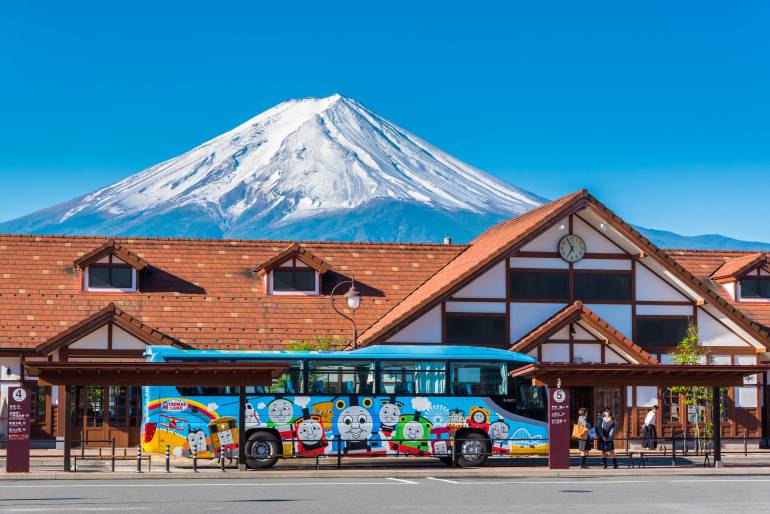 Kawaguchiko station with Mt Fuji and a bus