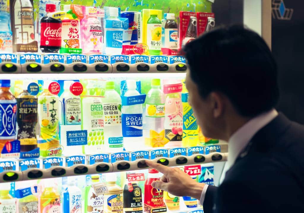 man in front of vending machine