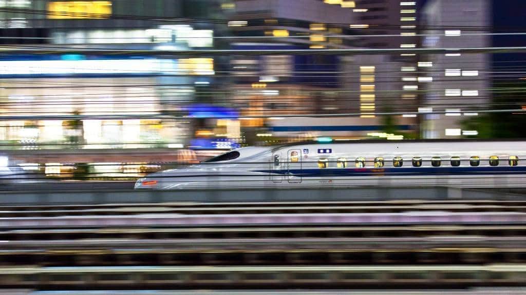N700 series Shinkansen bullet train passes by Hamamatsu-cho in the night.