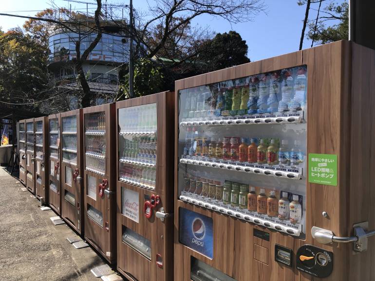 a line of brown-colored vending machines at the middle observation area of Mount Takao, Tokyo